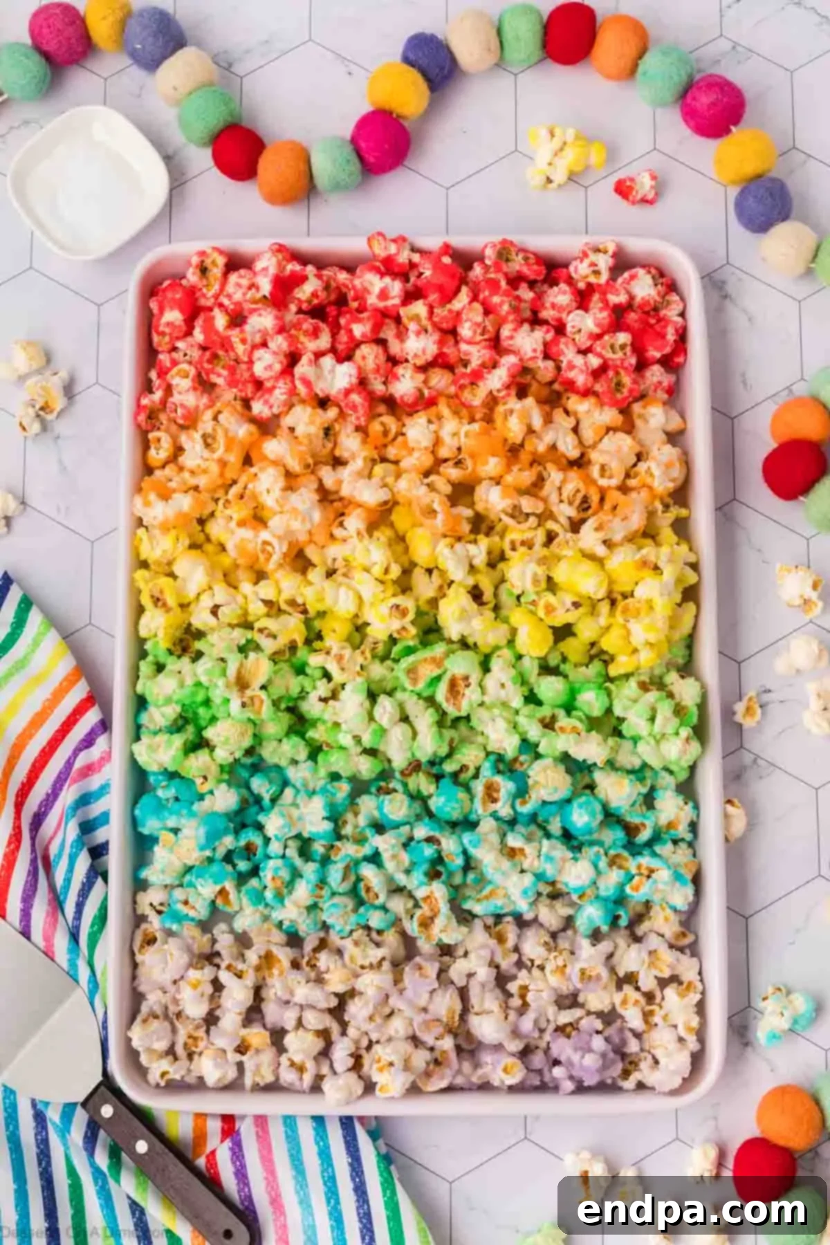 Kaleidoscope Kernels 13 Popcorn spread on baking sheet in different colors.