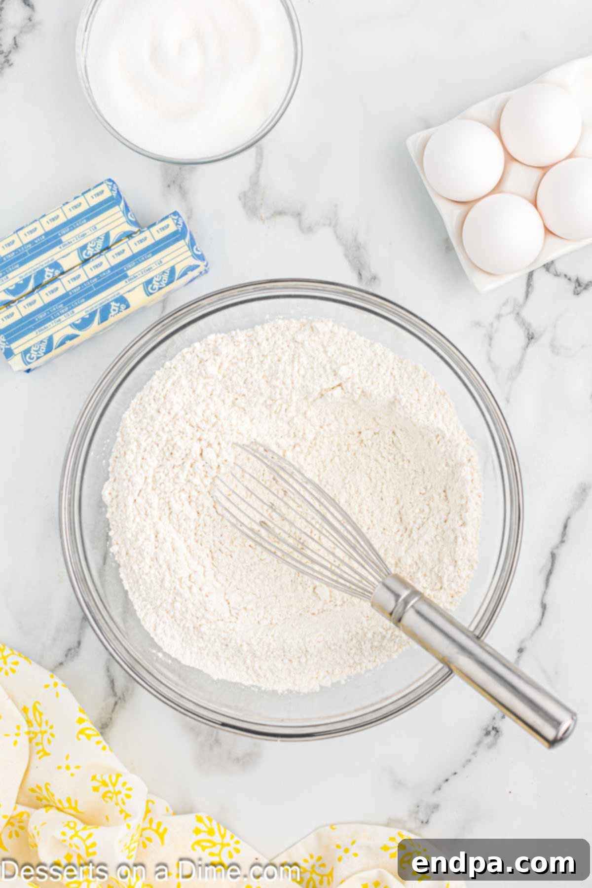 Sunshine Lemon Cake 4 Mixing bowl with dry ingredients, including flour, baking powder, and salt.
