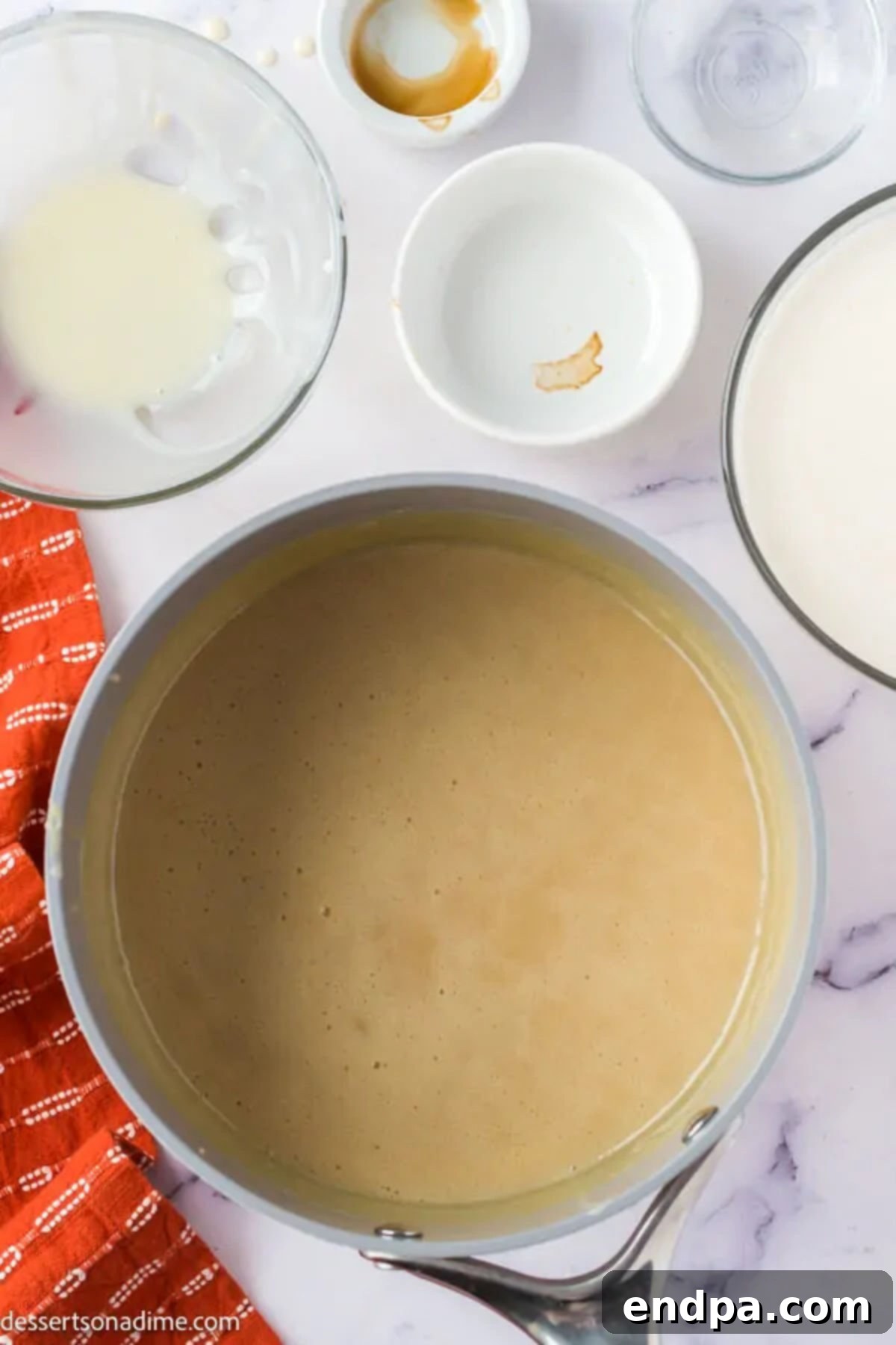 Saucepan with butterscotch mixture, showing a thick, combined consistency after cooking, ready to be removed from heat and cooled.