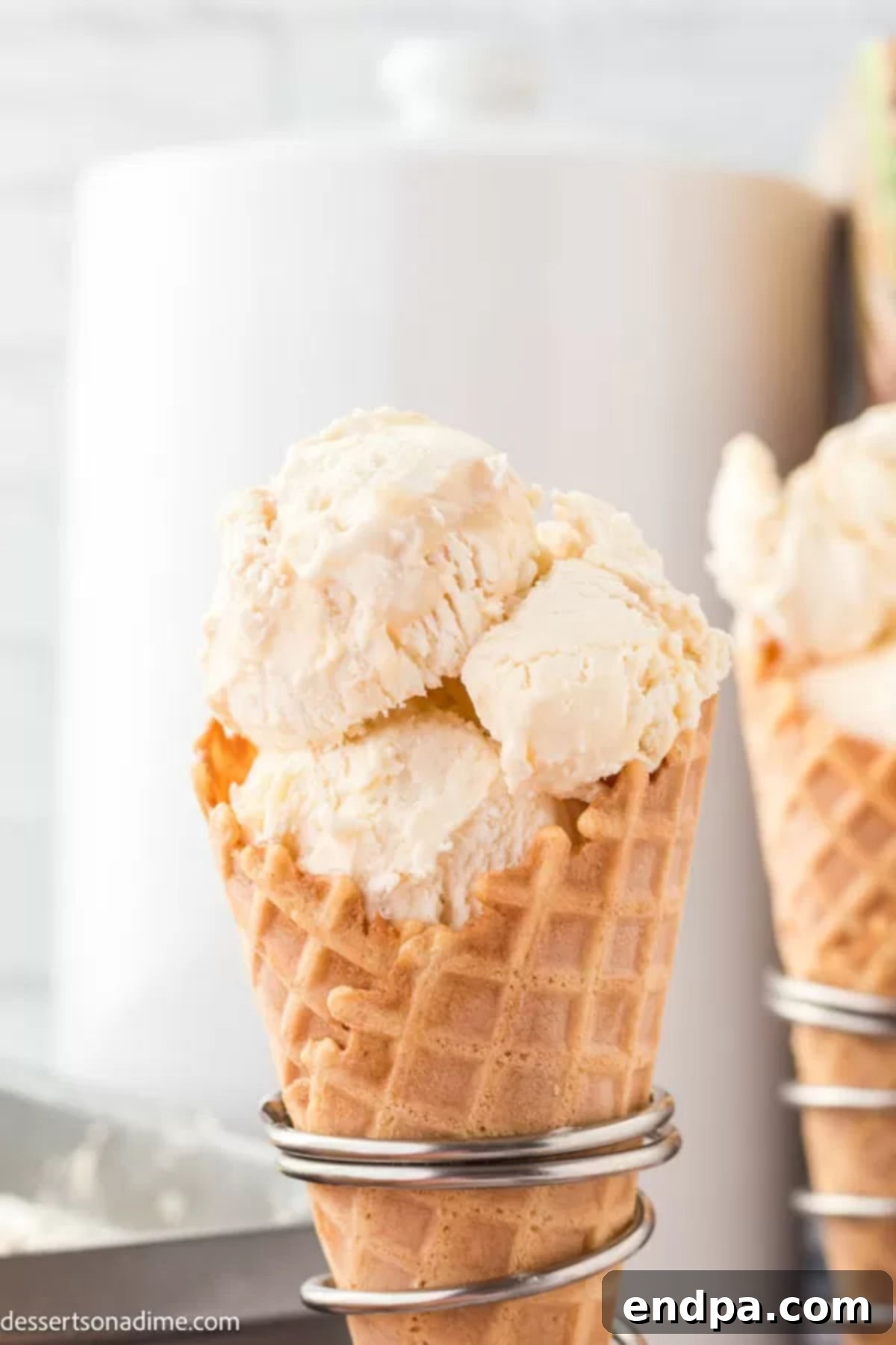 A second view of the Butterbeer ice cream served in a cone, highlighting its inviting, golden-brown swirls and creamy texture, a perfect frozen delight.