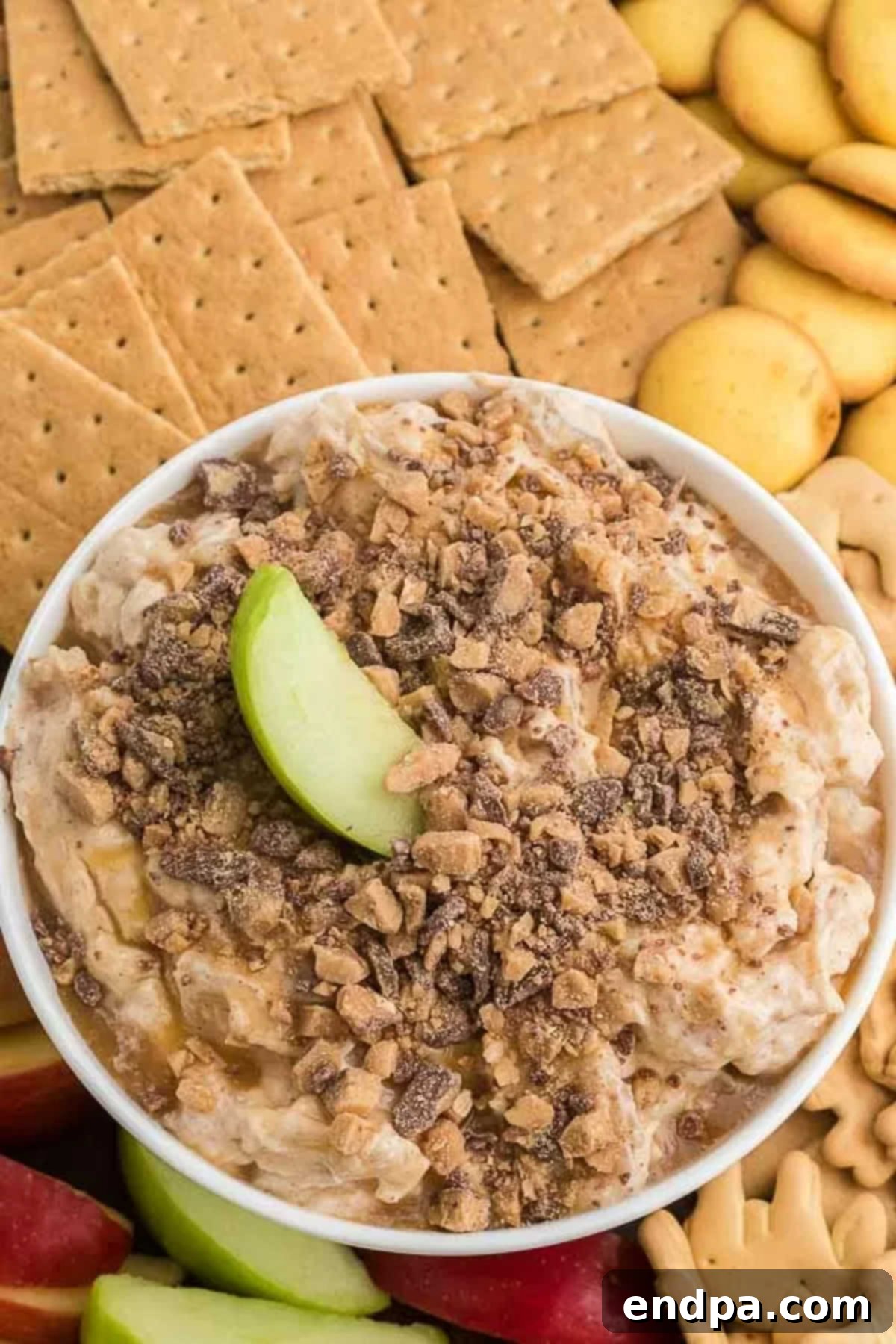 Caramel apple cheesecake dip in a bowl, ready to be served.