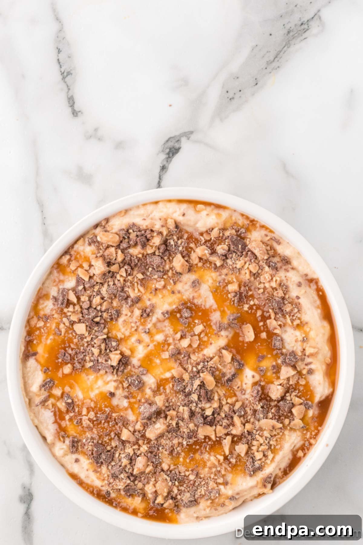 Toffee bits sprinkled on top of the caramel apple cheesecake dip.