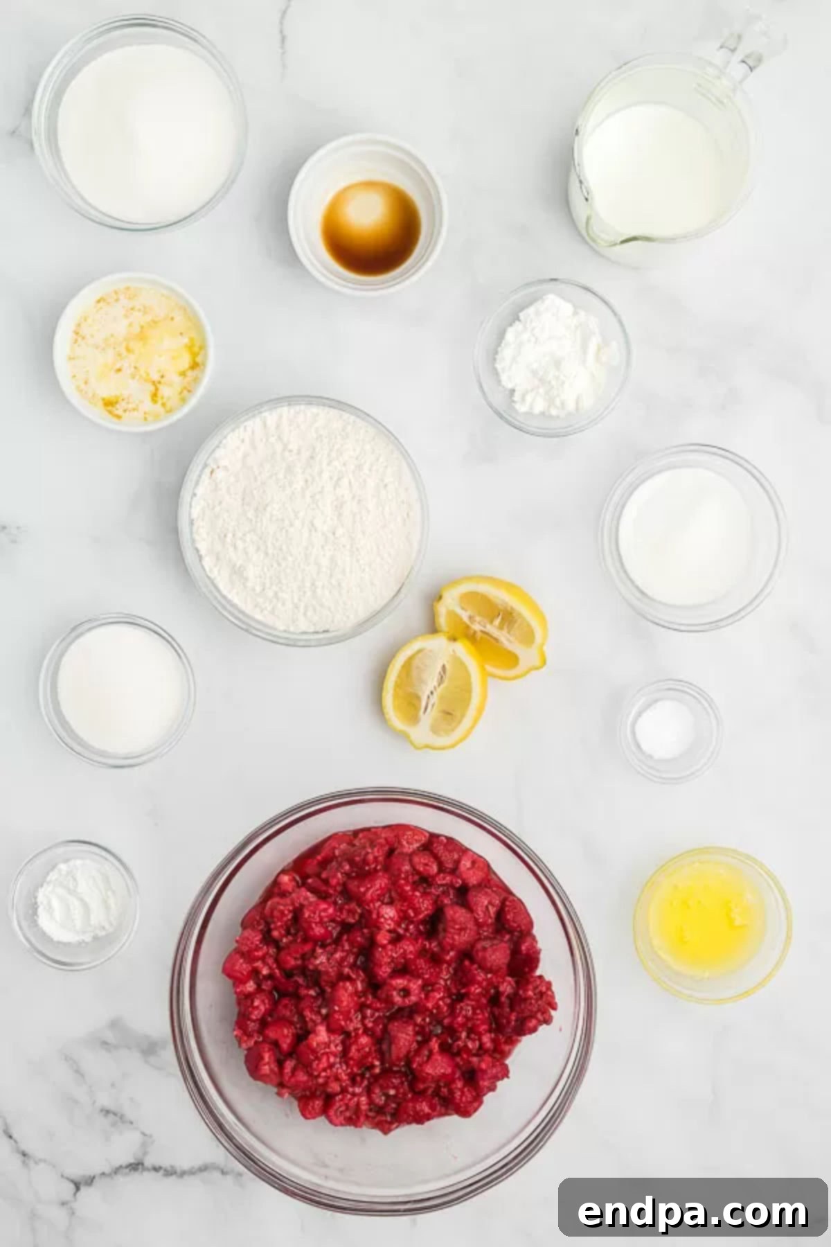 Ingredients needed for raspberry cobbler: raspberries, lemon, sugar, cornstarch, butter, milk, salt, baking powder, flour, vanilla extract.