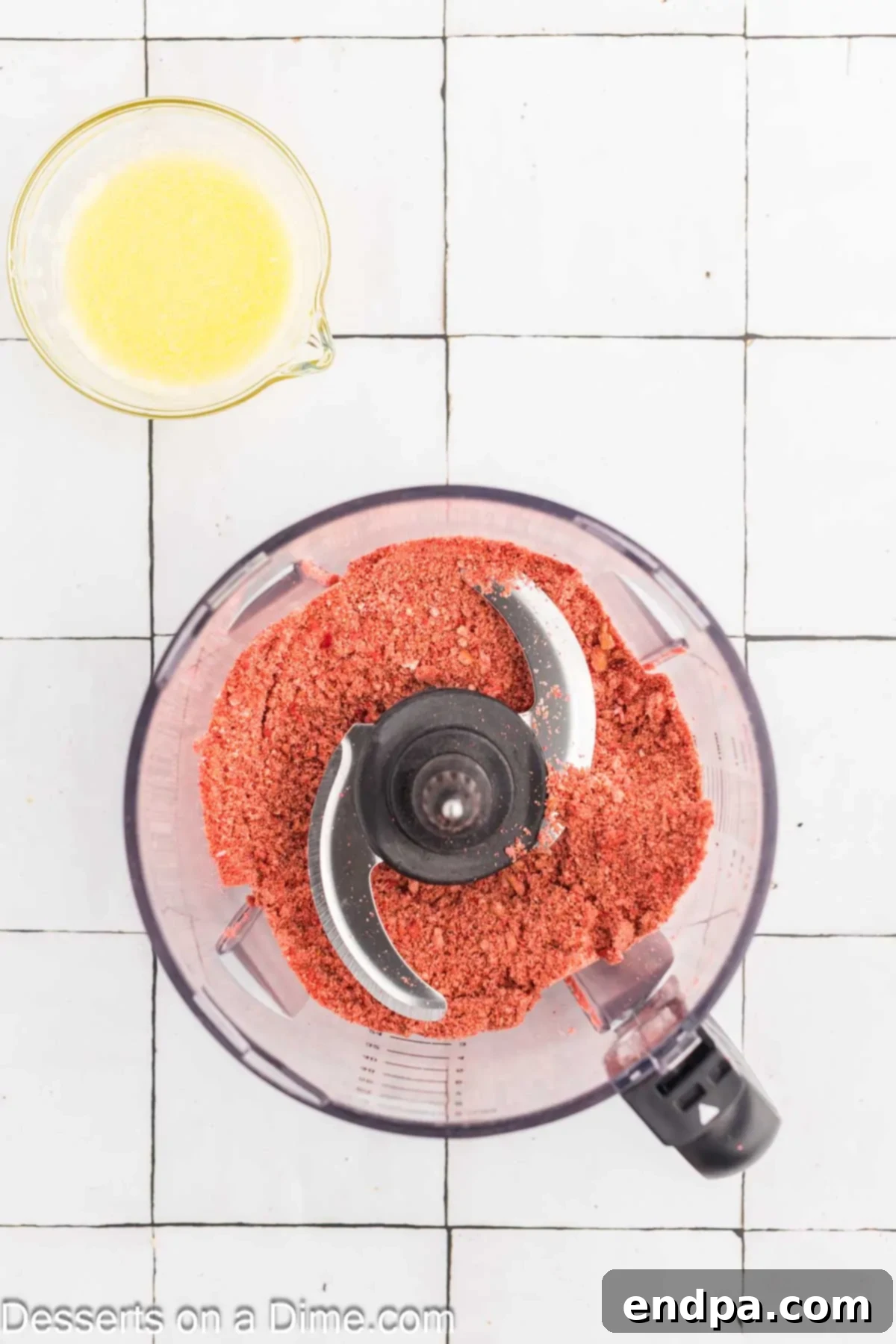 Close-up of the strawberry shortcake crunch topping mixture on a plate, ready for coating popsicles.