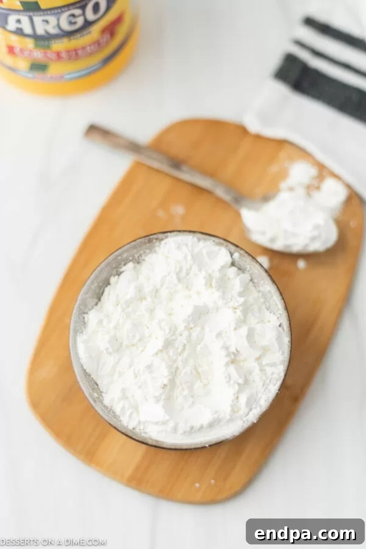 A bowl of cornstarch, highlighting its fine texture and versatility.
