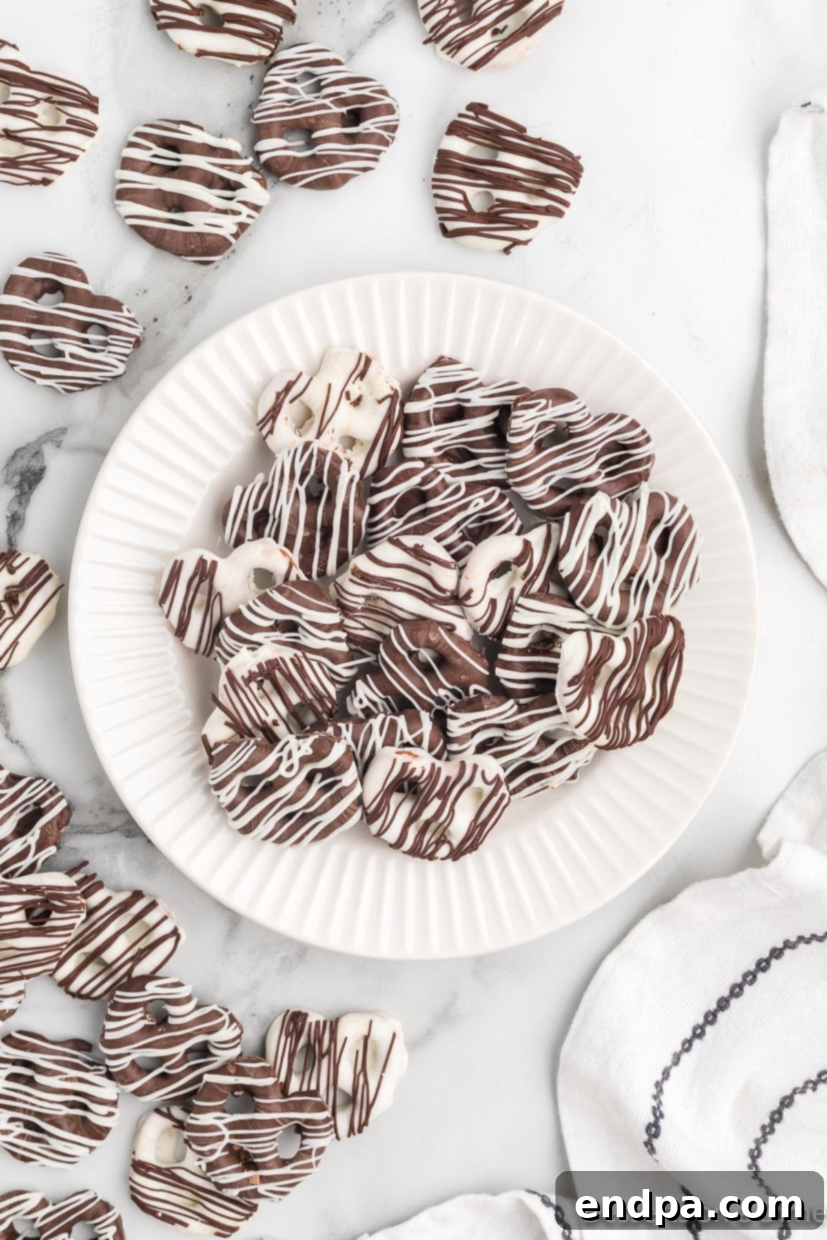 A beautifully arranged plate of chocolate covered pretzels, showcasing their delicious appeal.