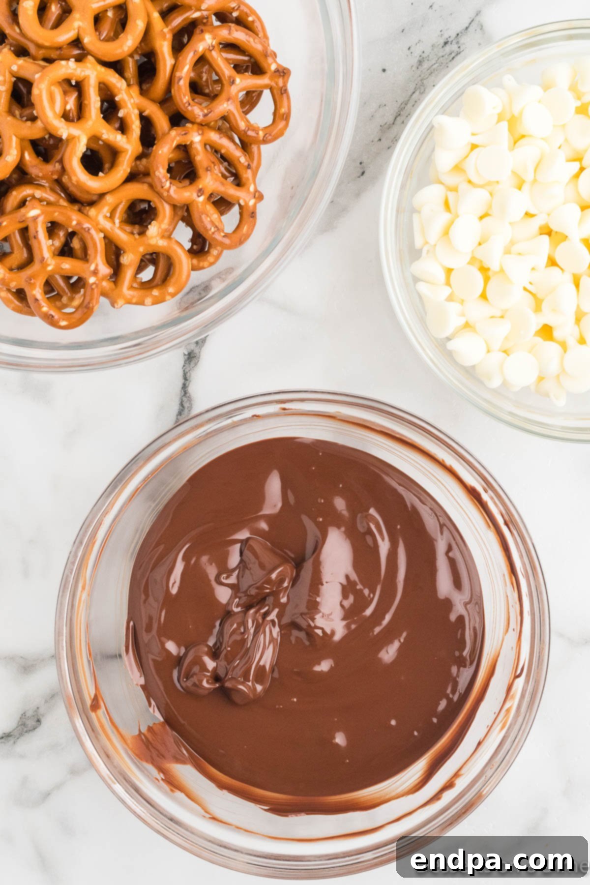 A bowl of melted milk chocolate, smooth and ready for dipping.