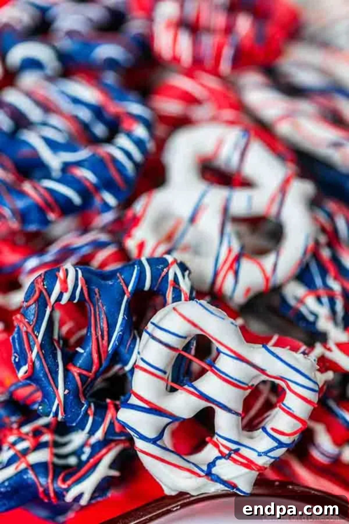Red, White, and Blue Chocolate Covered Pretzels - a festive and tasty treat for 4th of July or Memorial Day.