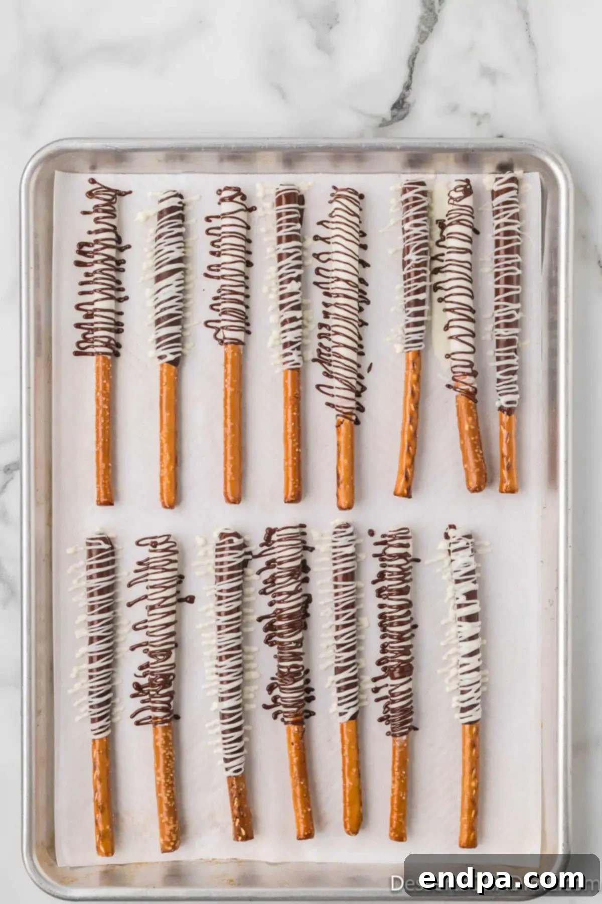 Melted chocolate drizzled on pretzels.