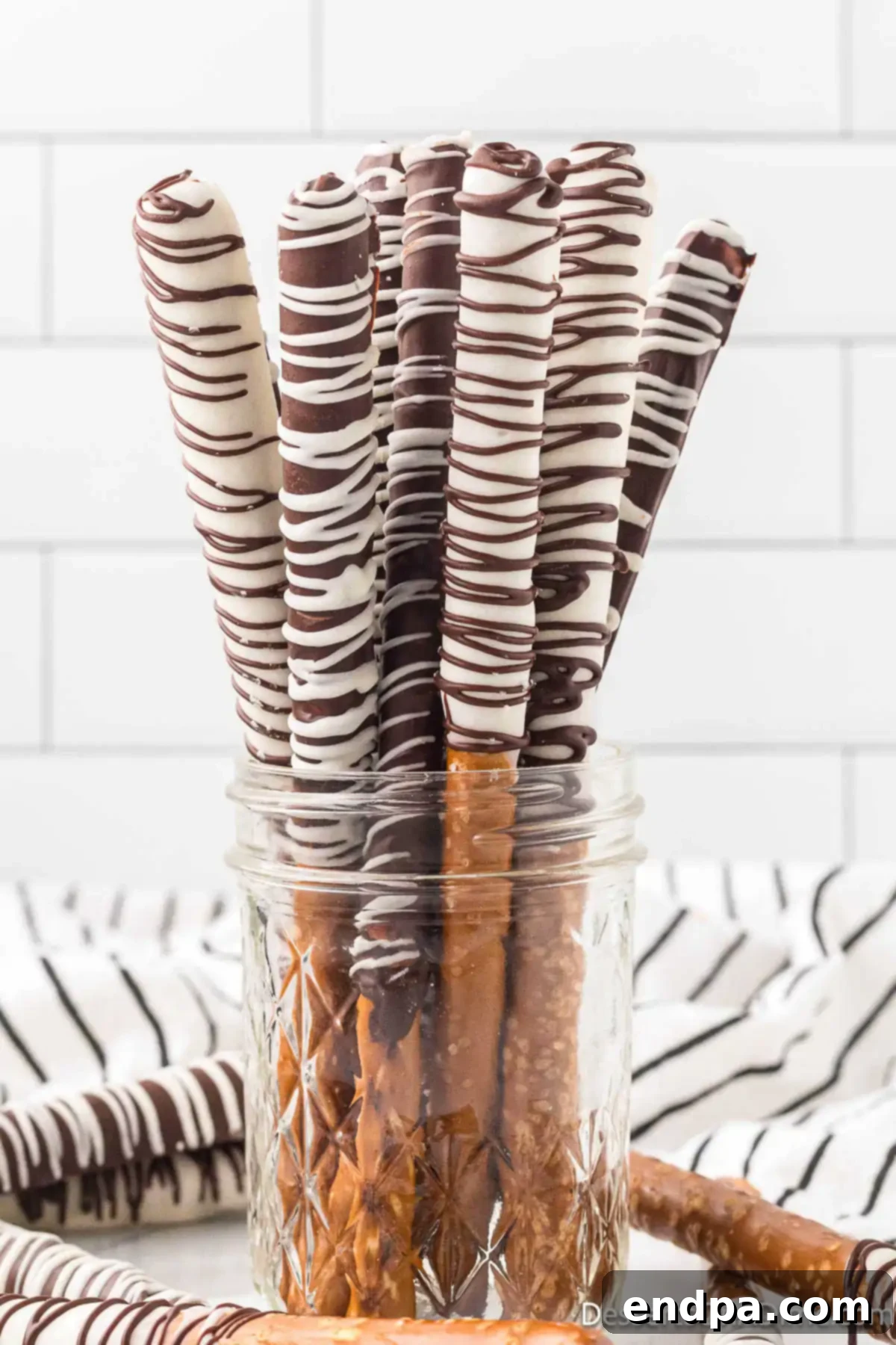 Chocolate covered pretzel rods in a mason jar
