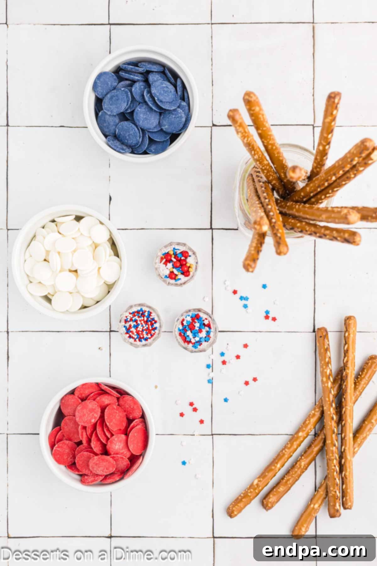Ingredients for chocolate covered pretzel rods including pretzel rods, red, white, and blue candy melts, and star sprinkles.