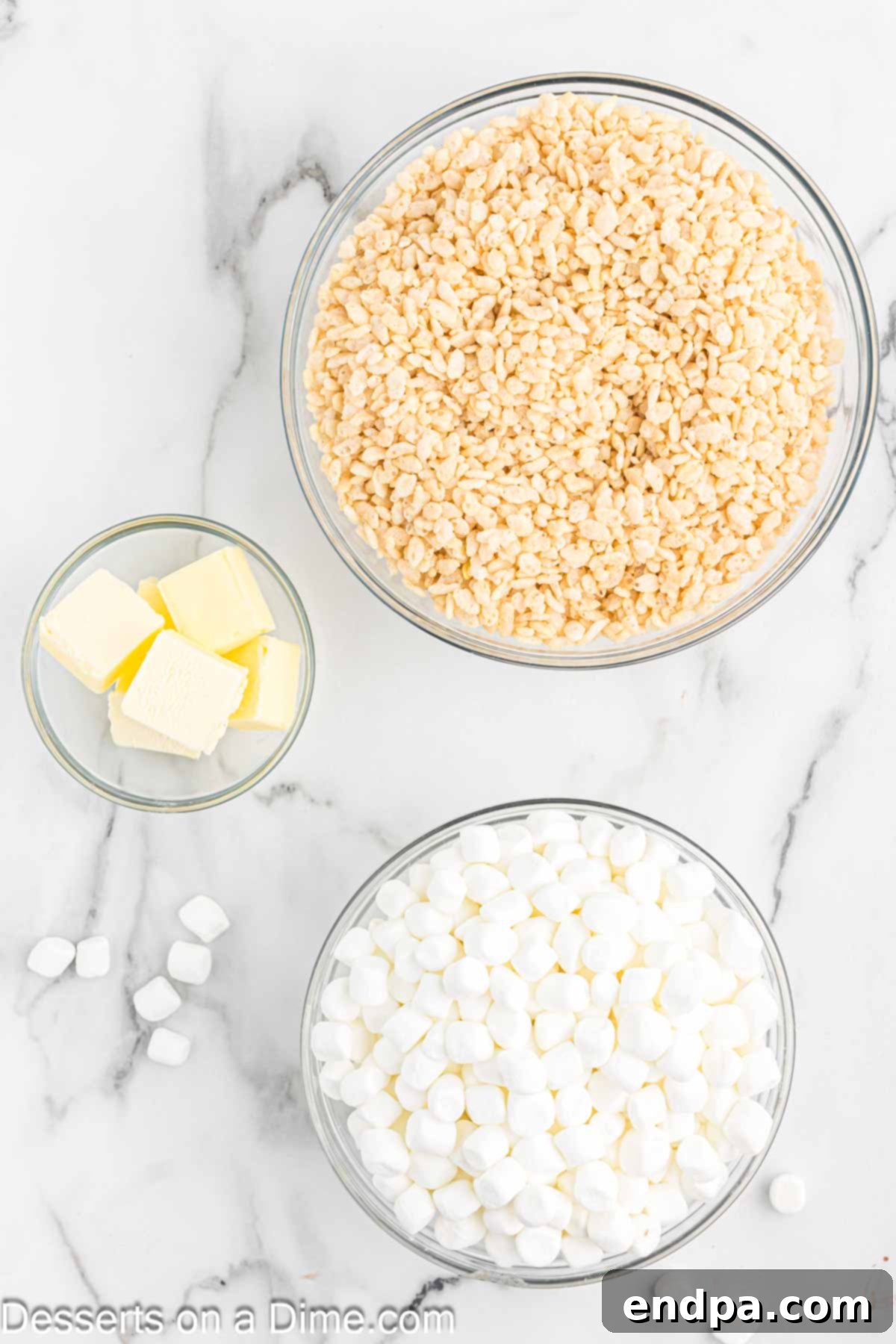 Crispy Marshmallow Bars 3 Close-up of the three essential ingredients for Rice Krispie treats: crispy rice cereal, butter sticks, and a bag of marshmallows.
