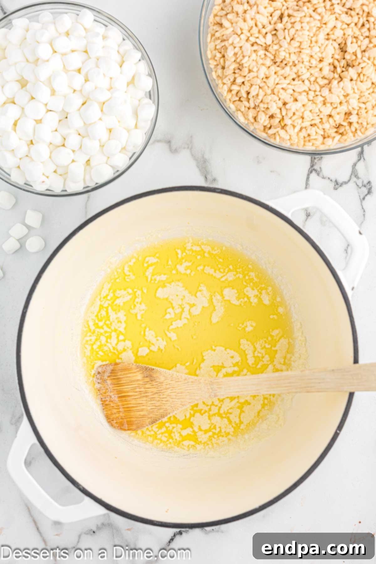 Crispy Marshmallow Bars 4 A large saucepan on a stovetop with melted butter, shimmering golden.