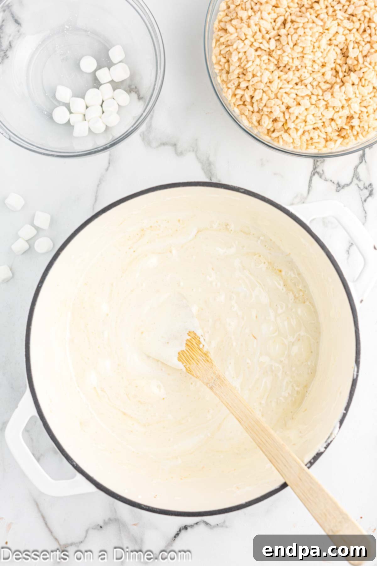 Crispy Marshmallow Bars 6 The marshmallow and butter mixture completely melted into a smooth, gooey white liquid in the saucepan.
