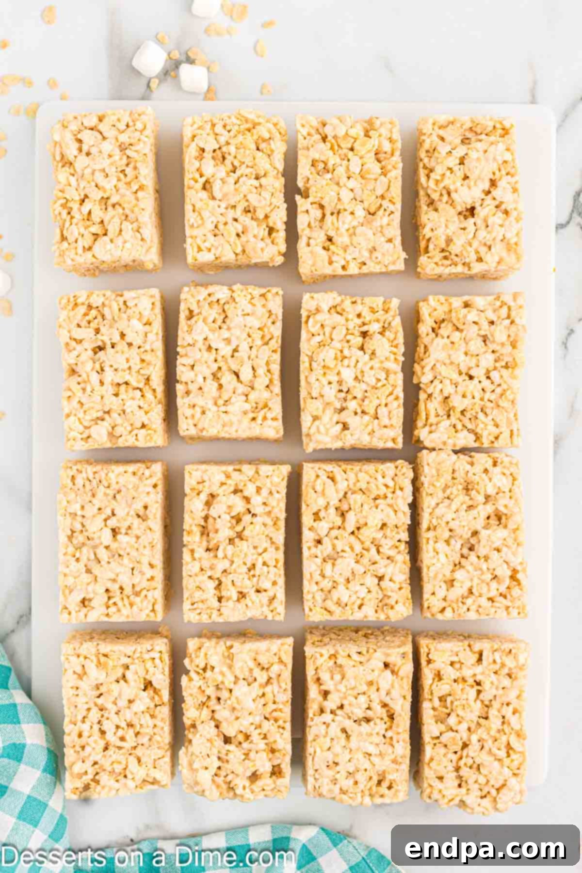 Crispy Marshmallow Bars 10 A pan of cooled Rice Krispie treats, neatly cut into squares.