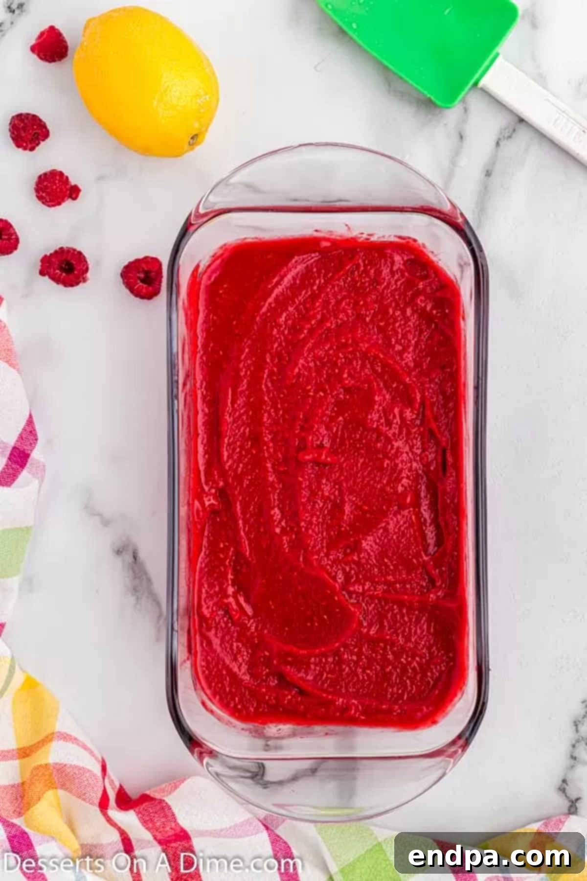 Tangy Raspberry Delight 5 The blended raspberry sorbet mixture neatly spread into a loaf pan, ready for freezing.