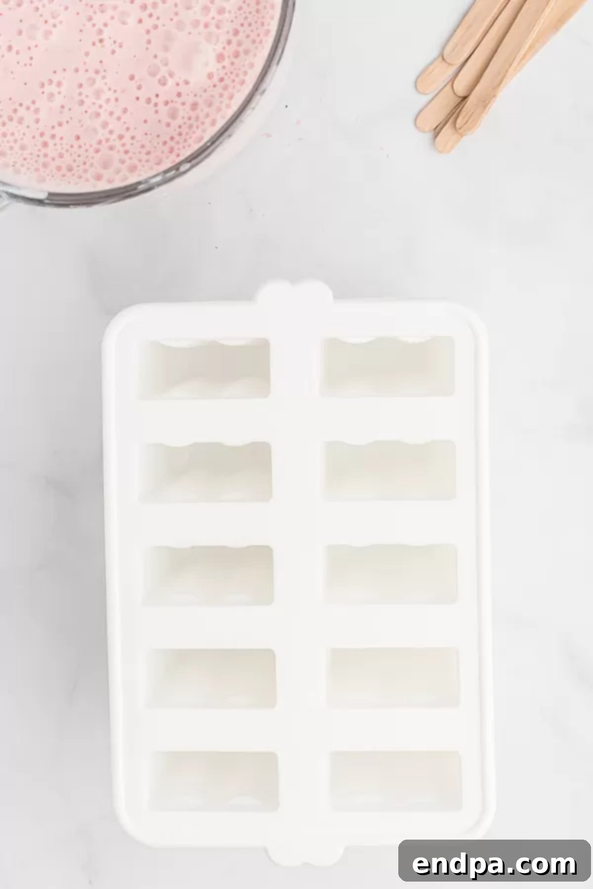 Berry Bliss Yogurt Pops 4 Popsicle mold on the counter.