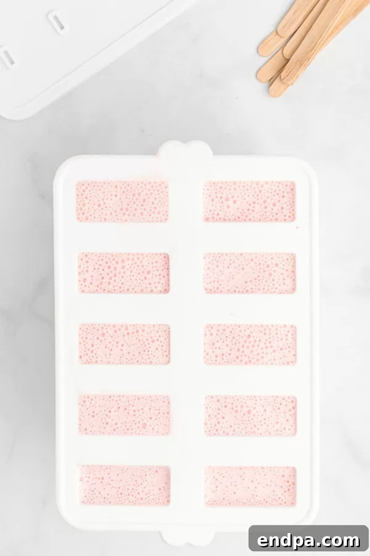 Berry Bliss Yogurt Pops 5 Yogurt mixture in popsicle molds.
