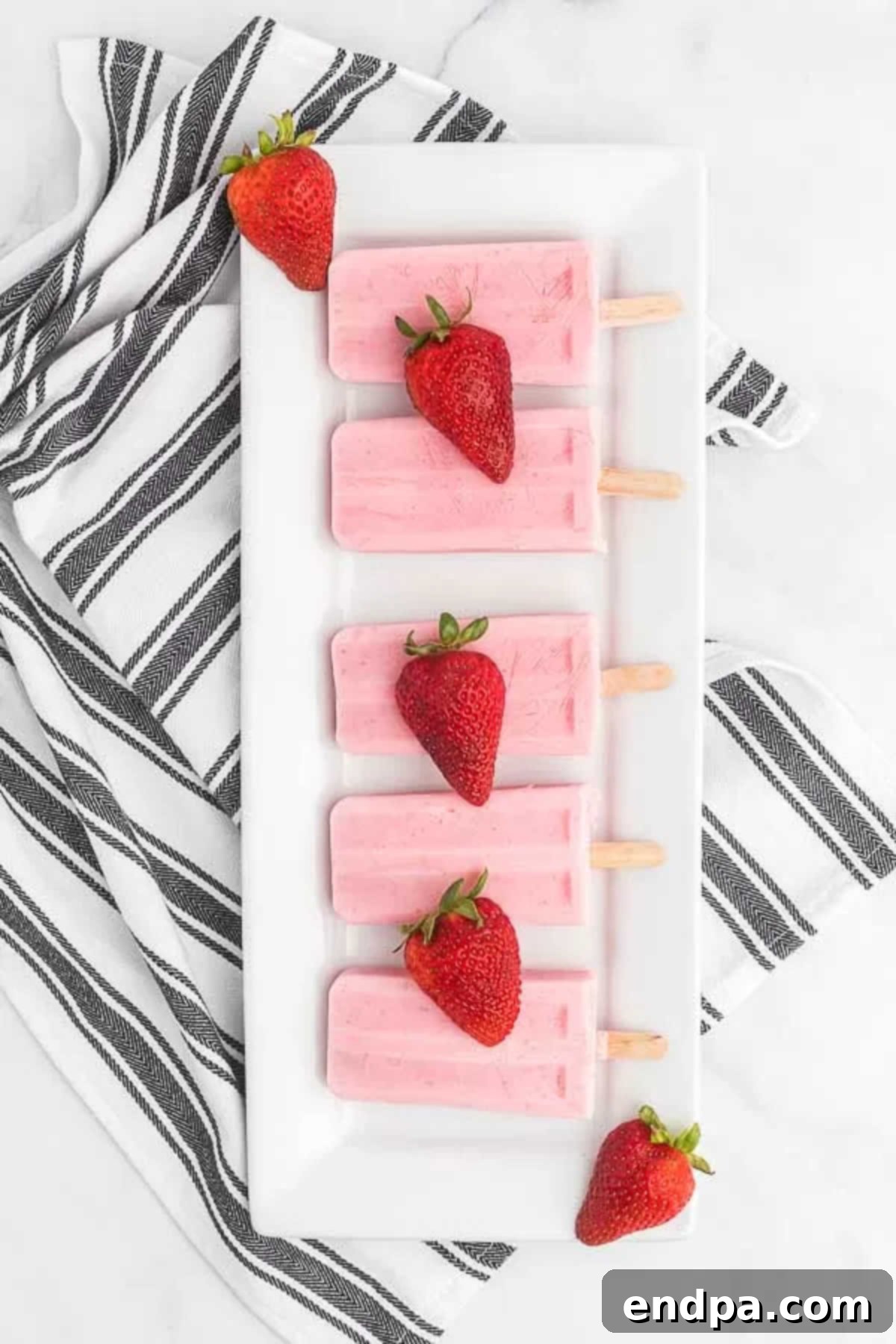 Berry Bliss Yogurt Pops 6 Strawberry yogurt popsicles on a platter.