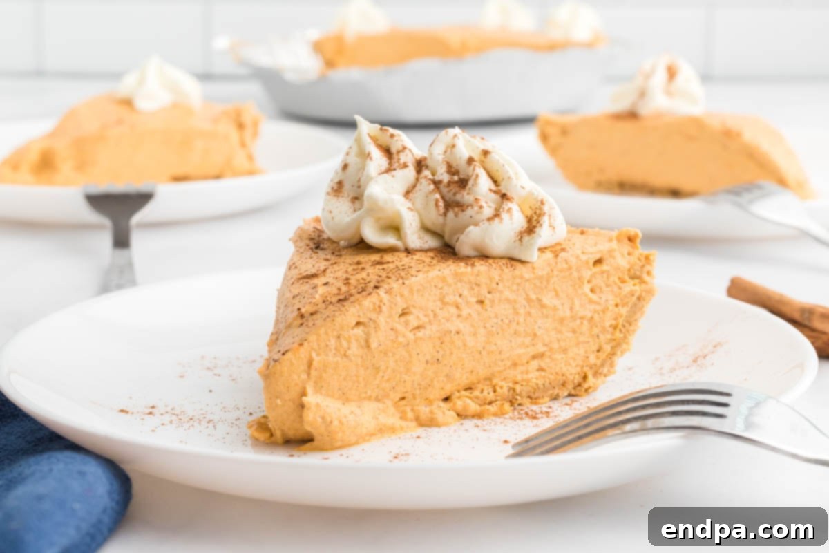 A slice of No Bake Pumpkin Cheesecake on a plate, showcasing its creamy texture and crust.