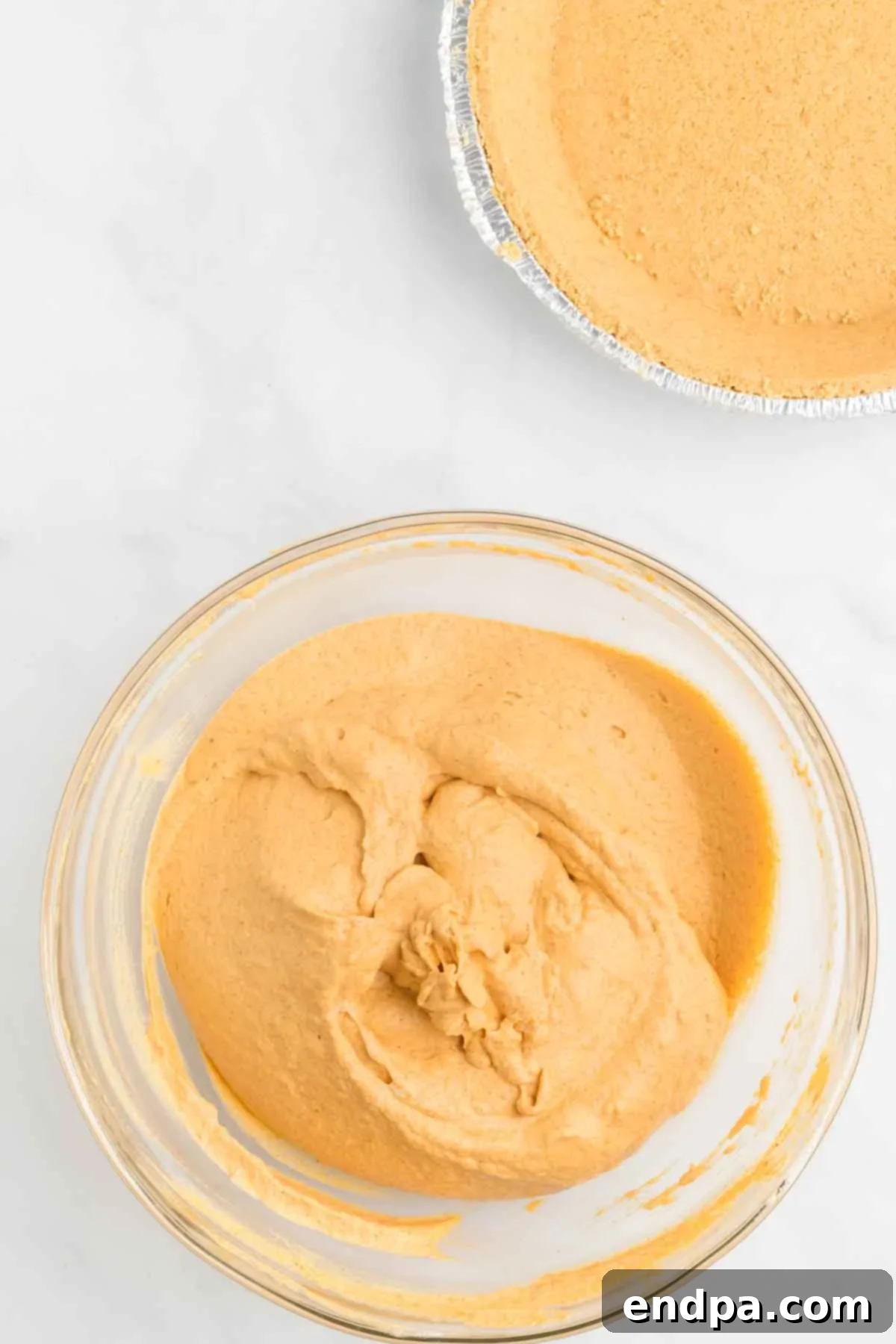 The pumpkin mixture is combined in a bowl, showing a smooth, consistent texture before adding whipped topping.