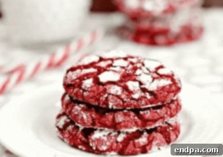 Stack of Red Velvet Cookies with white drizzle.
