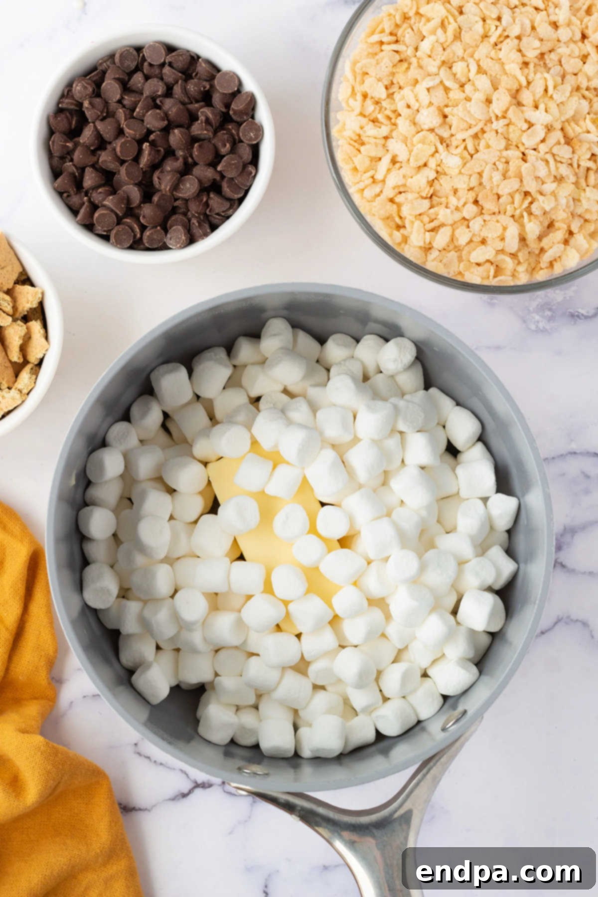 No-Bake S'mores Rice Krispie Treats 4 Saucepan with marshmallows and butter.