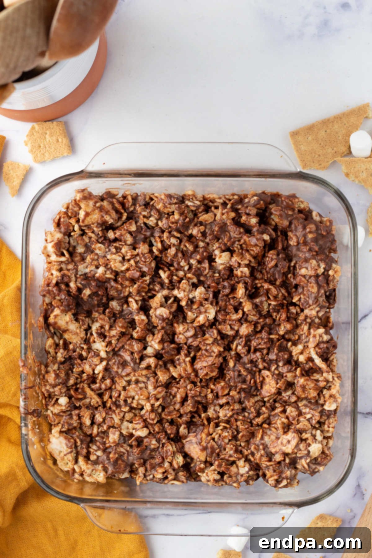 No-Bake S'mores Rice Krispie Treats 6 Mixture spread into pan.