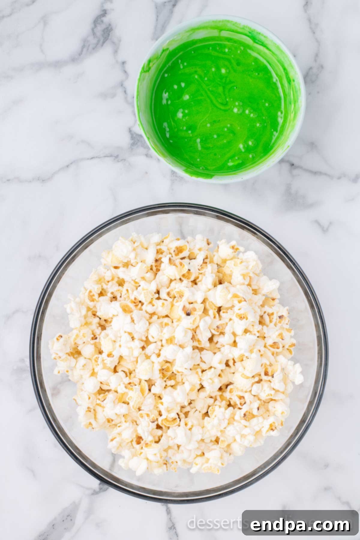 Festive Grinch Popcorn Mix 5 Popcorn in a large mixing bowl, ready to be coated.