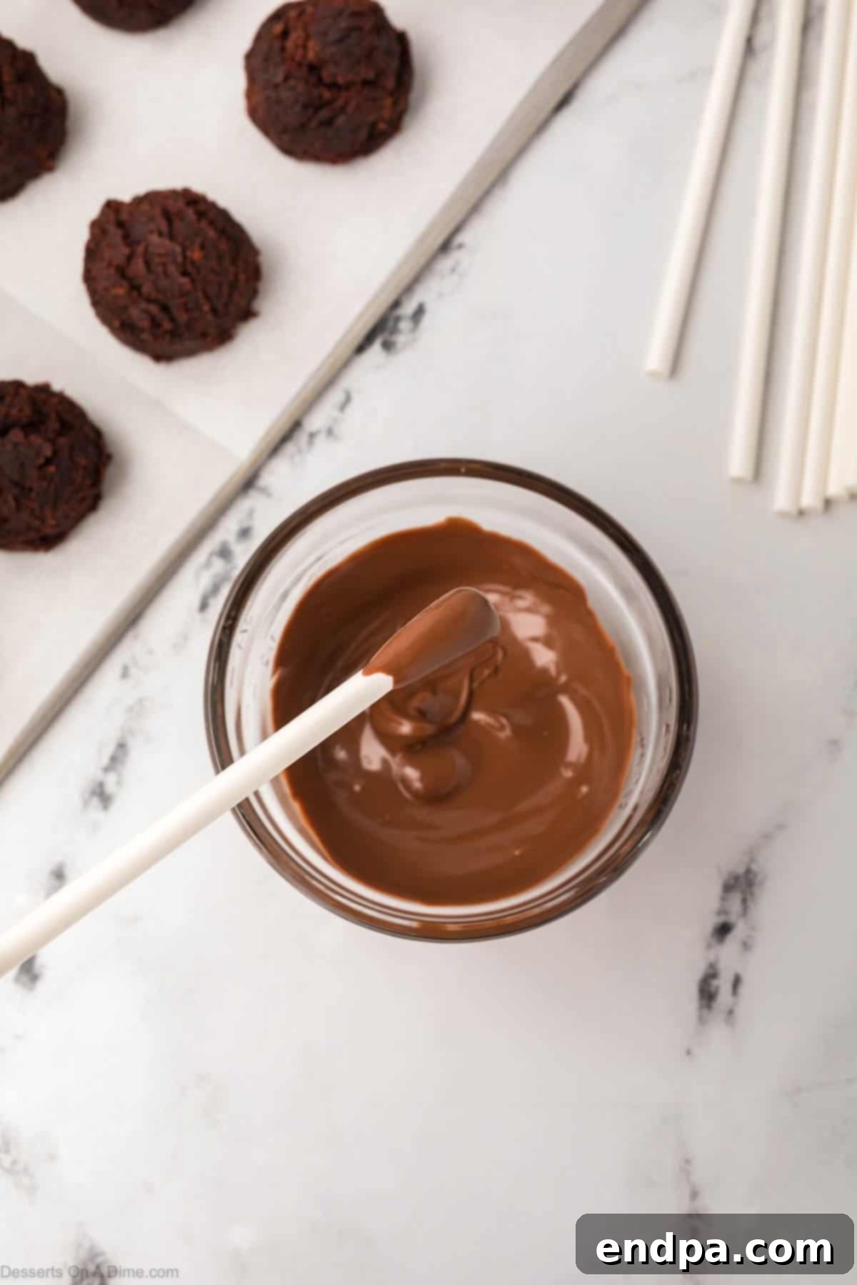 Lollipop sticks dipped into melted chocolate candy melts.