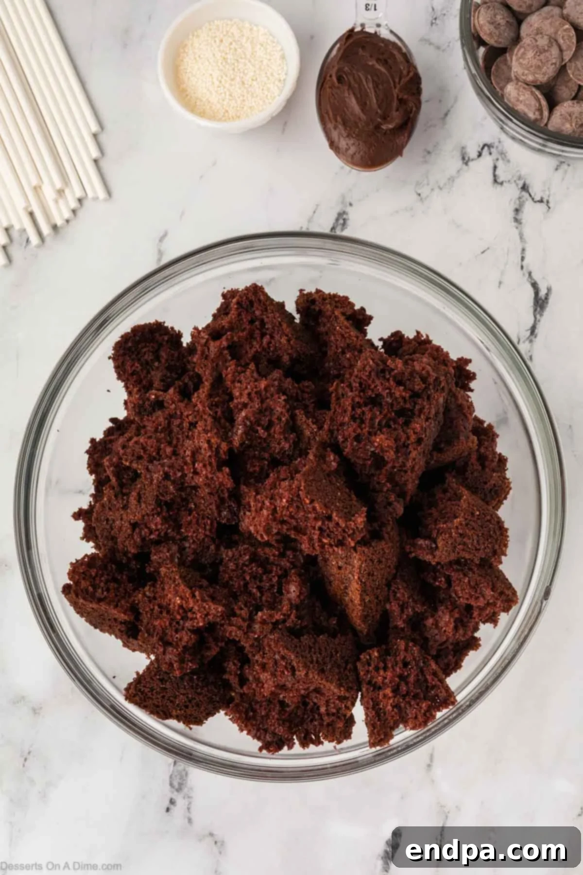 Interior of chocolate cake crumbled into a large mixing bowl.