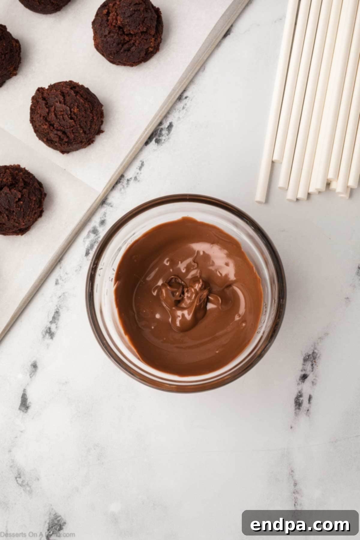 Chocolate candy melts melted in a small microwave-safe bowl.