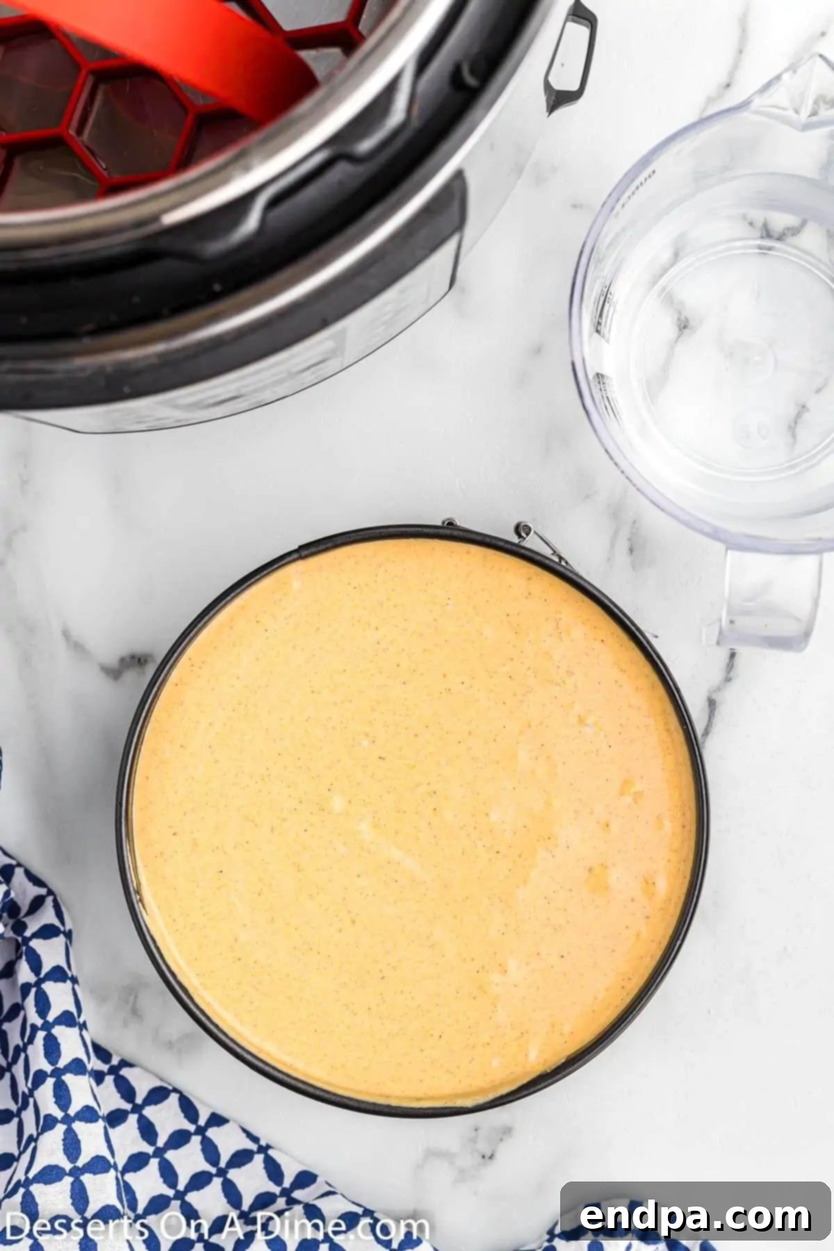 The smooth pumpkin cheesecake filling poured over the graham cracker crust in a springform pan.
