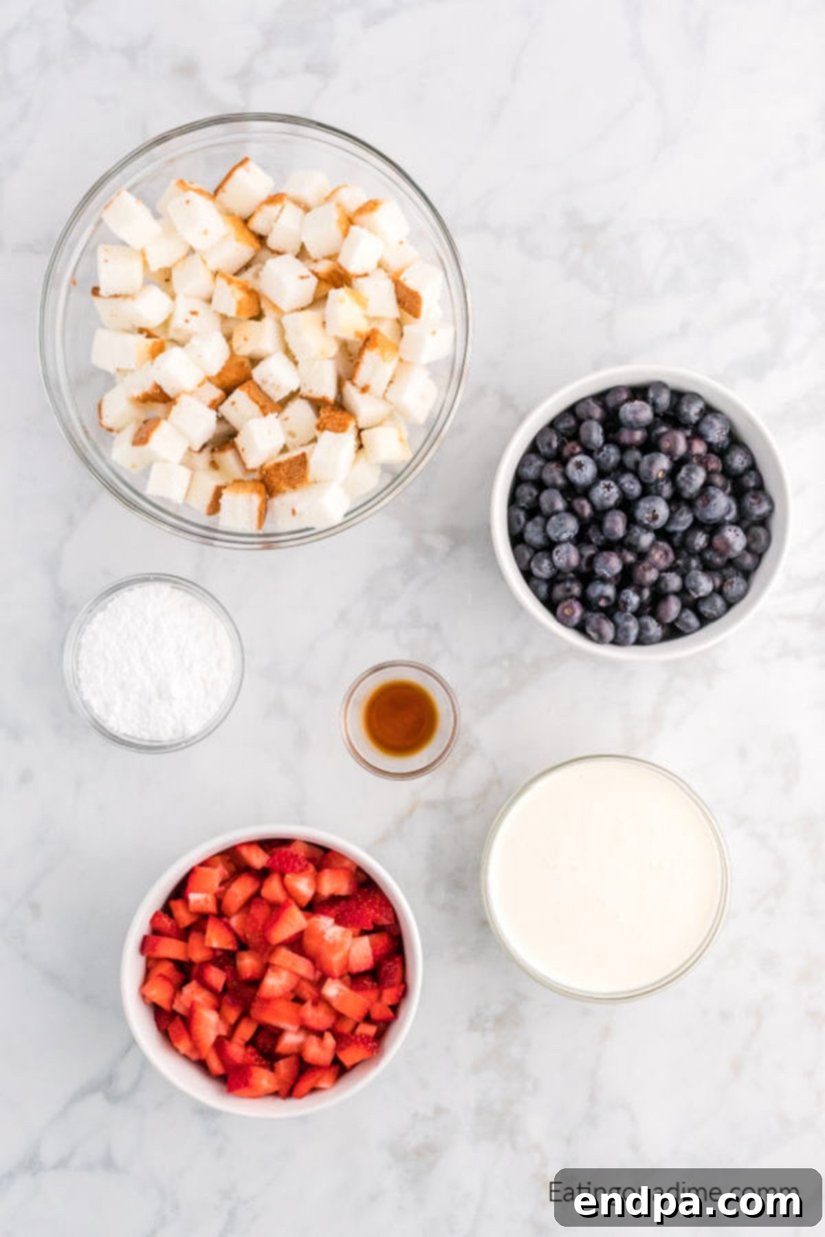 Ingredients needed - angel food cake, strawberries, blueberries, heavy whipping cream, powdered sugar, vanilla extract