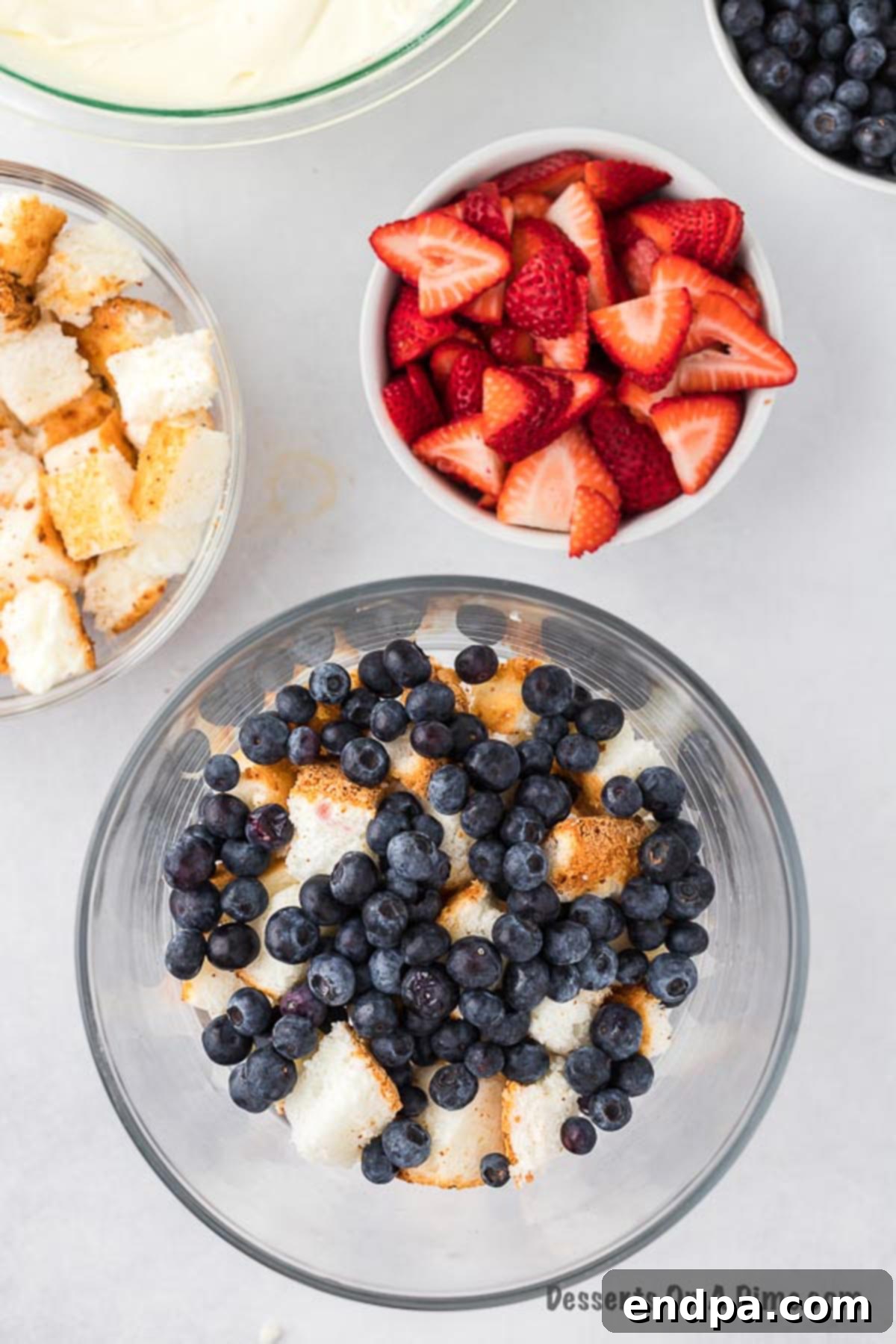 Cake and berries layered in trifle dish.
