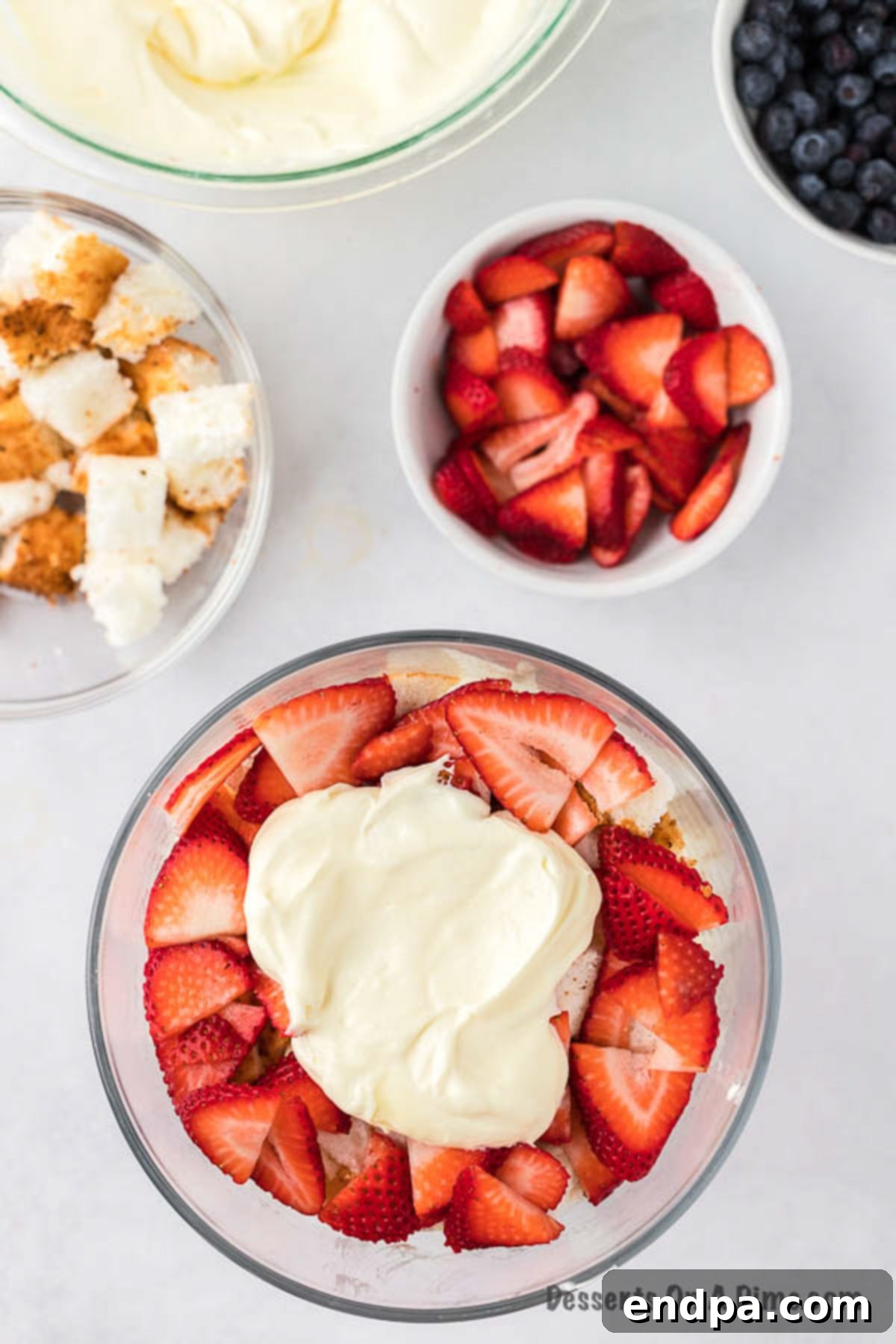 Strawberry layer topped with whipped cream.