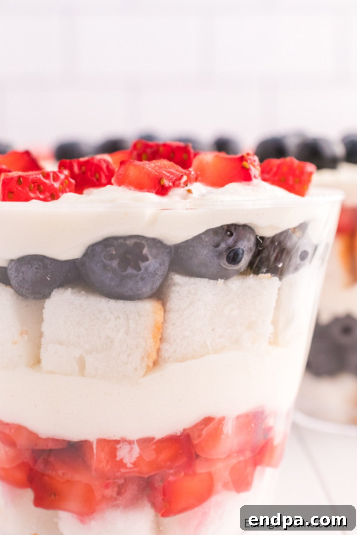 Fruit and cake layered in clear cups.