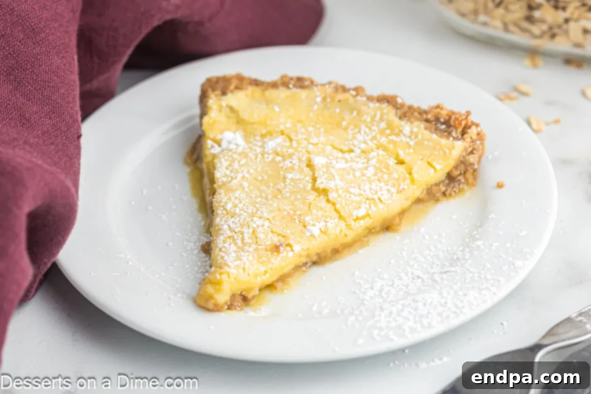 Golden Butter Crunch Pie 2 Slice of crack pie on a plate, topped with a dusting of confectioner's sugar, ready to be enjoyed.