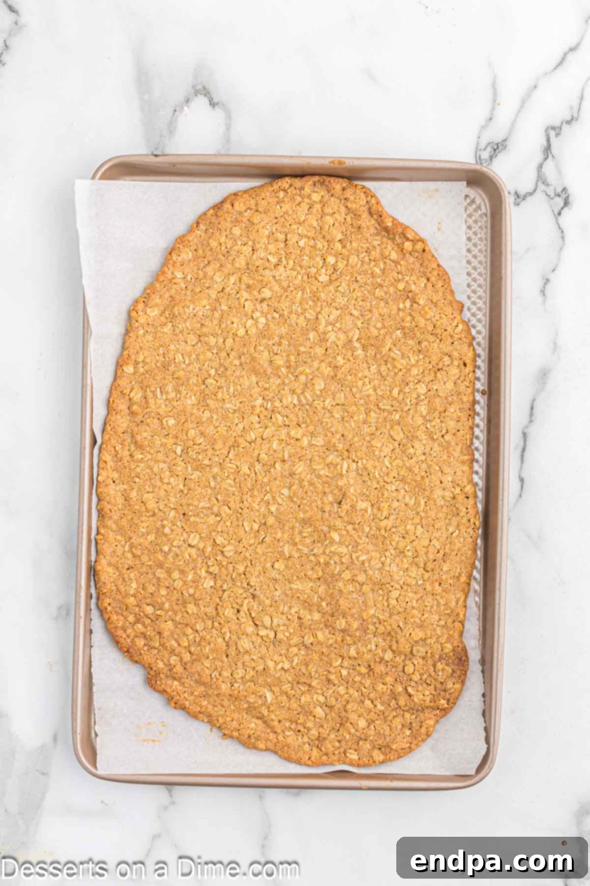 Golden Butter Crunch Pie 8 The baked oat cookie crust, golden brown and set on the edges, resting on a baking sheet.