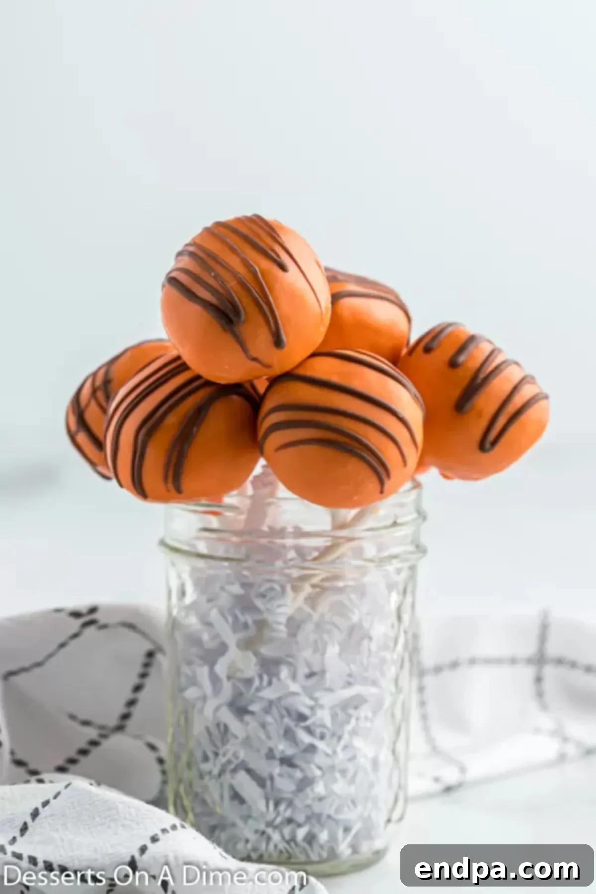 A glass jar filled with pumpkin cake pops, ready for serving or gifting.