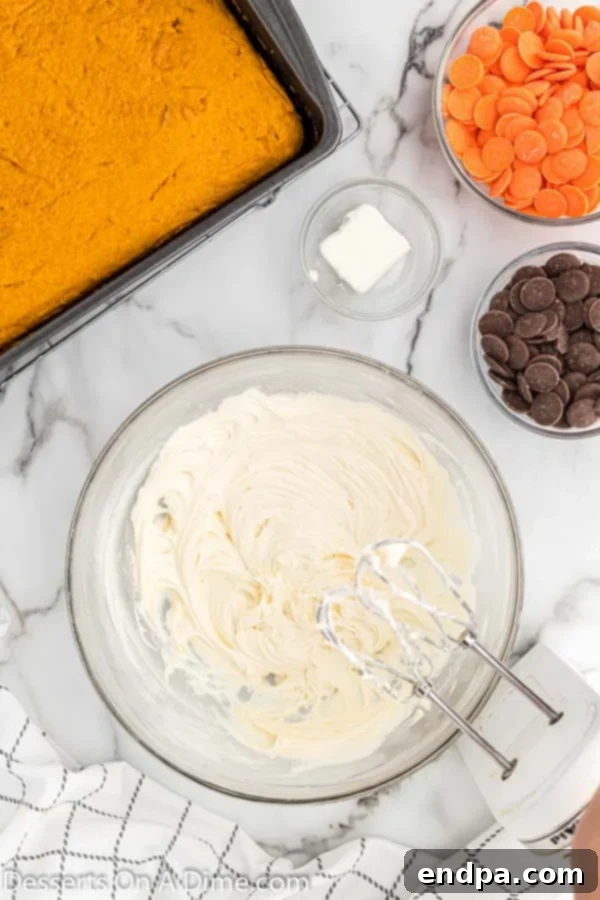 Mixing bowl with softened butter, cream cheese, and powdered sugar for making frosting.