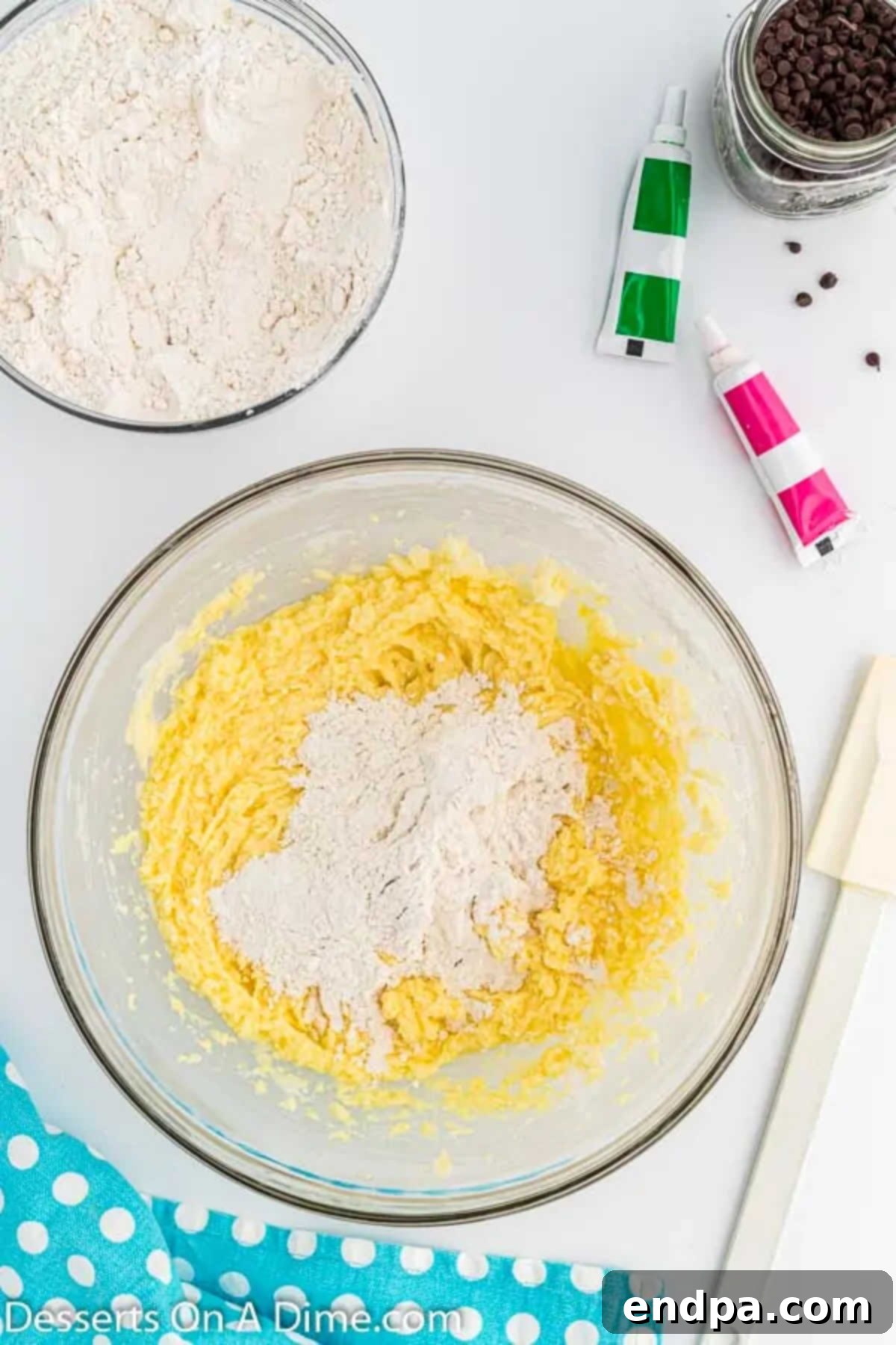 Summer Melon Bites 5 Flour mixture being gradually added to the wet ingredients in a bowl.