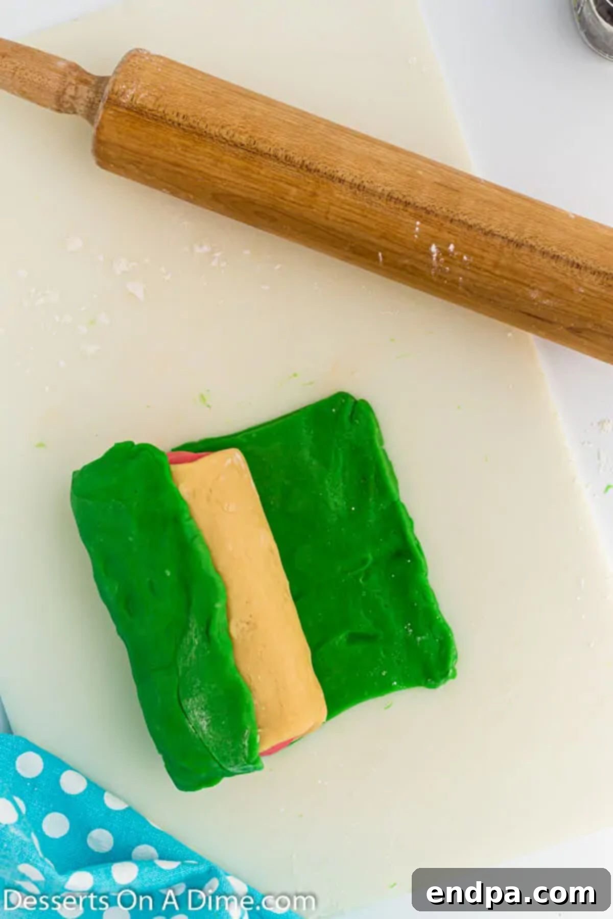 Summer Melon Bites 8 The fully assembled dough log, featuring pink, white, and green layers, wrapped and ready for chilling.