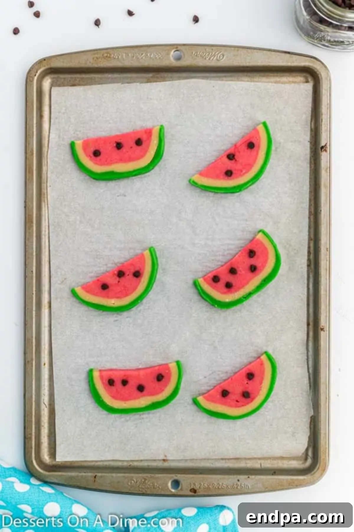 Summer Melon Bites 10 Mini chocolate chips carefully placed on the pink sections of the watermelon cookies to resemble seeds.