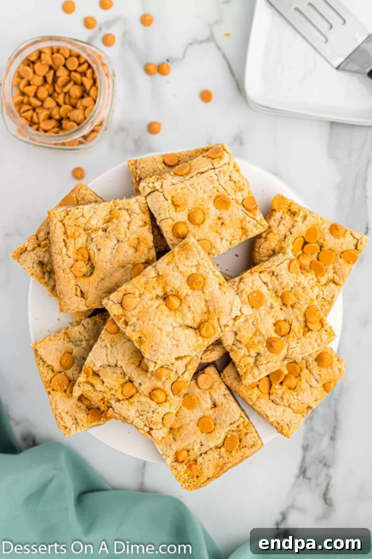 Irresistible Butterscotch Squares 12 Butterscotch bars arranged on a white plate, highlighting their golden color.
