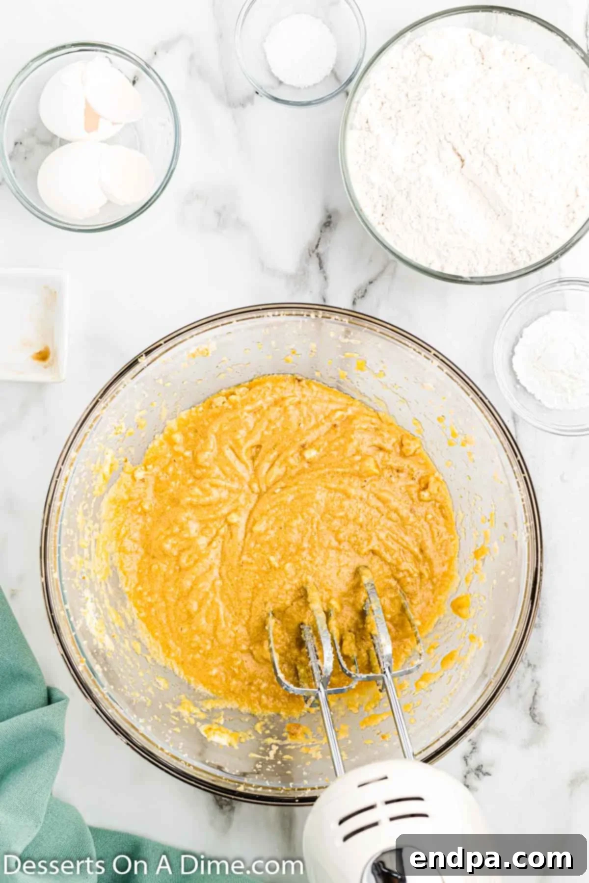 Irresistible Butterscotch Squares 5 Vanilla extract and eggs being added to the creamed butter and sugar mixture.