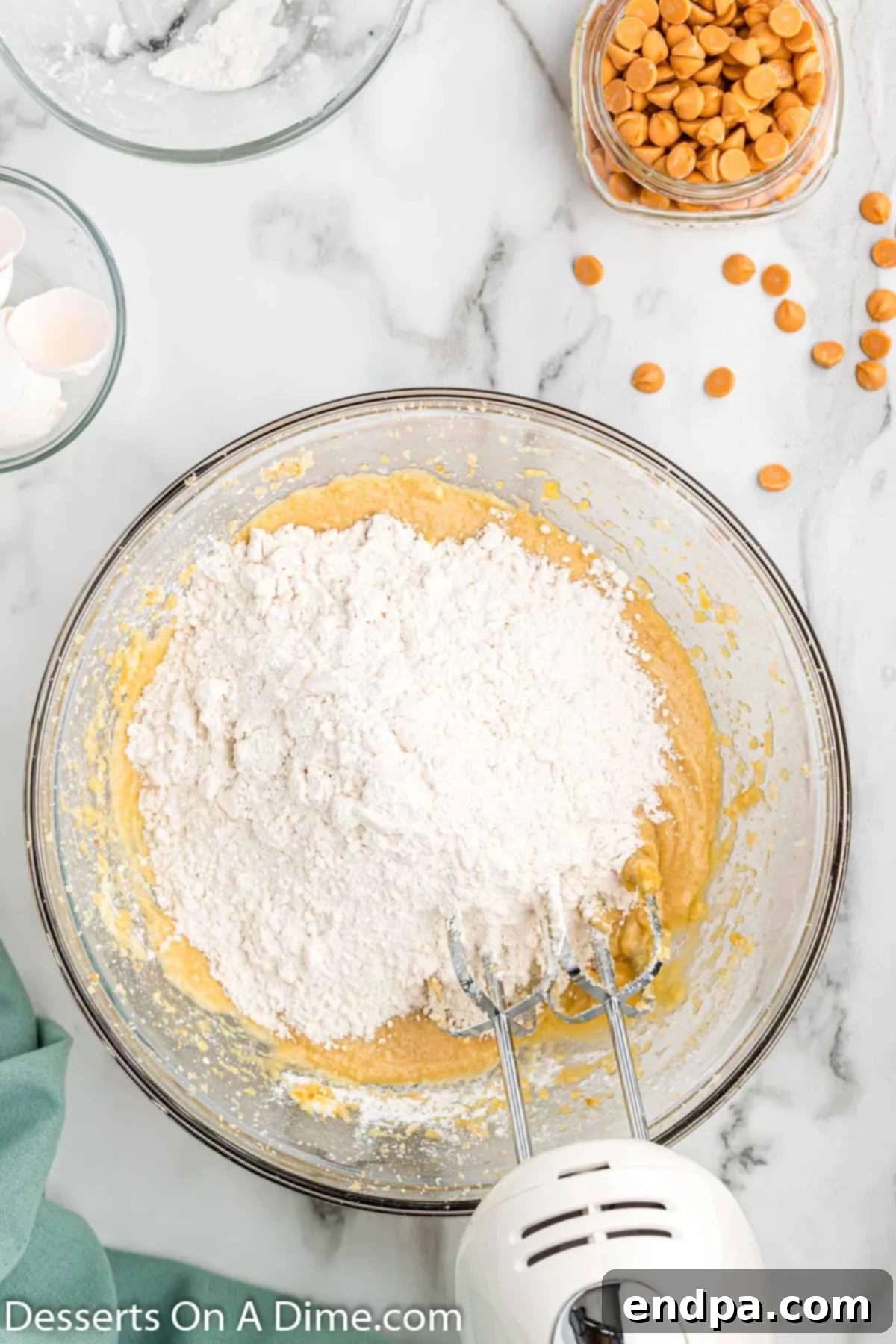 Irresistible Butterscotch Squares 6 Dry ingredients (flour, salt, baking powder) being mixed into the wet batter on low speed.