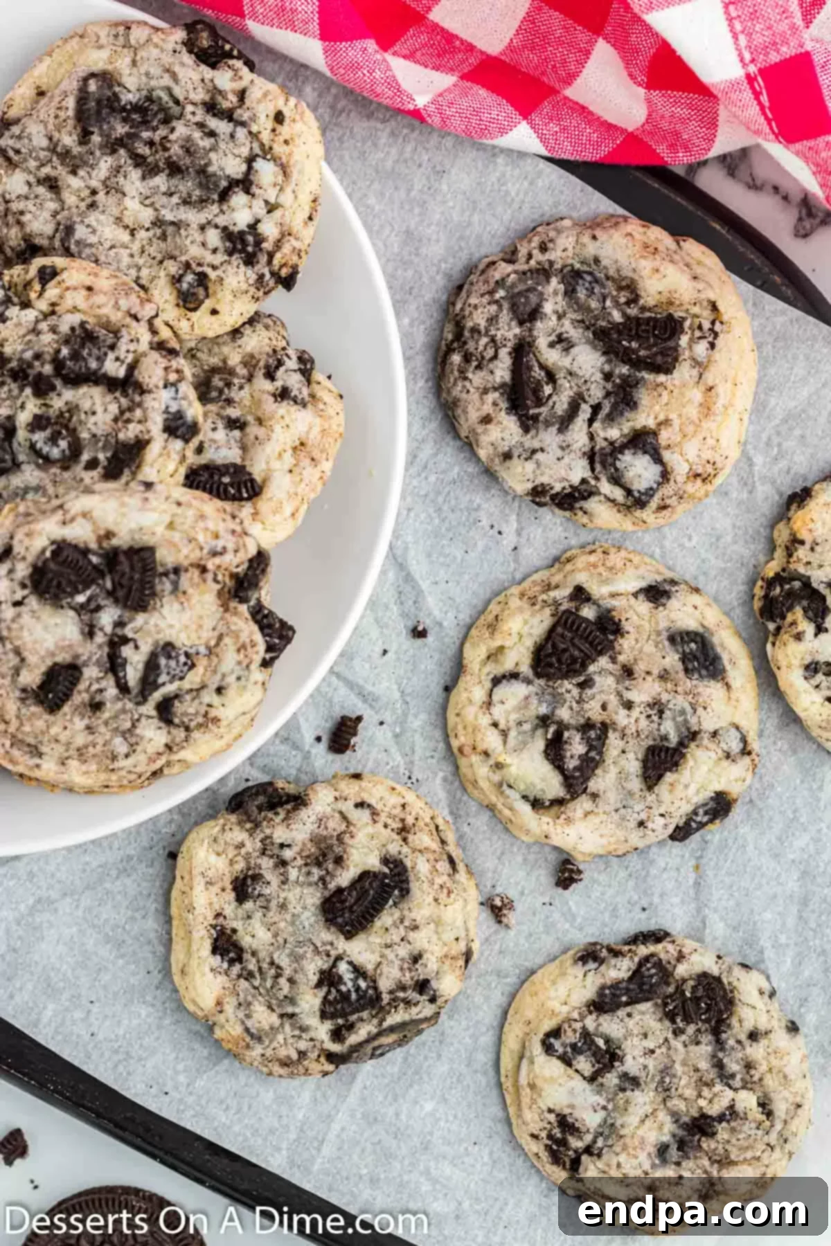 A stack of golden brown Oreo cheesecake cookies on wax paper, highlighting their delightful texture.