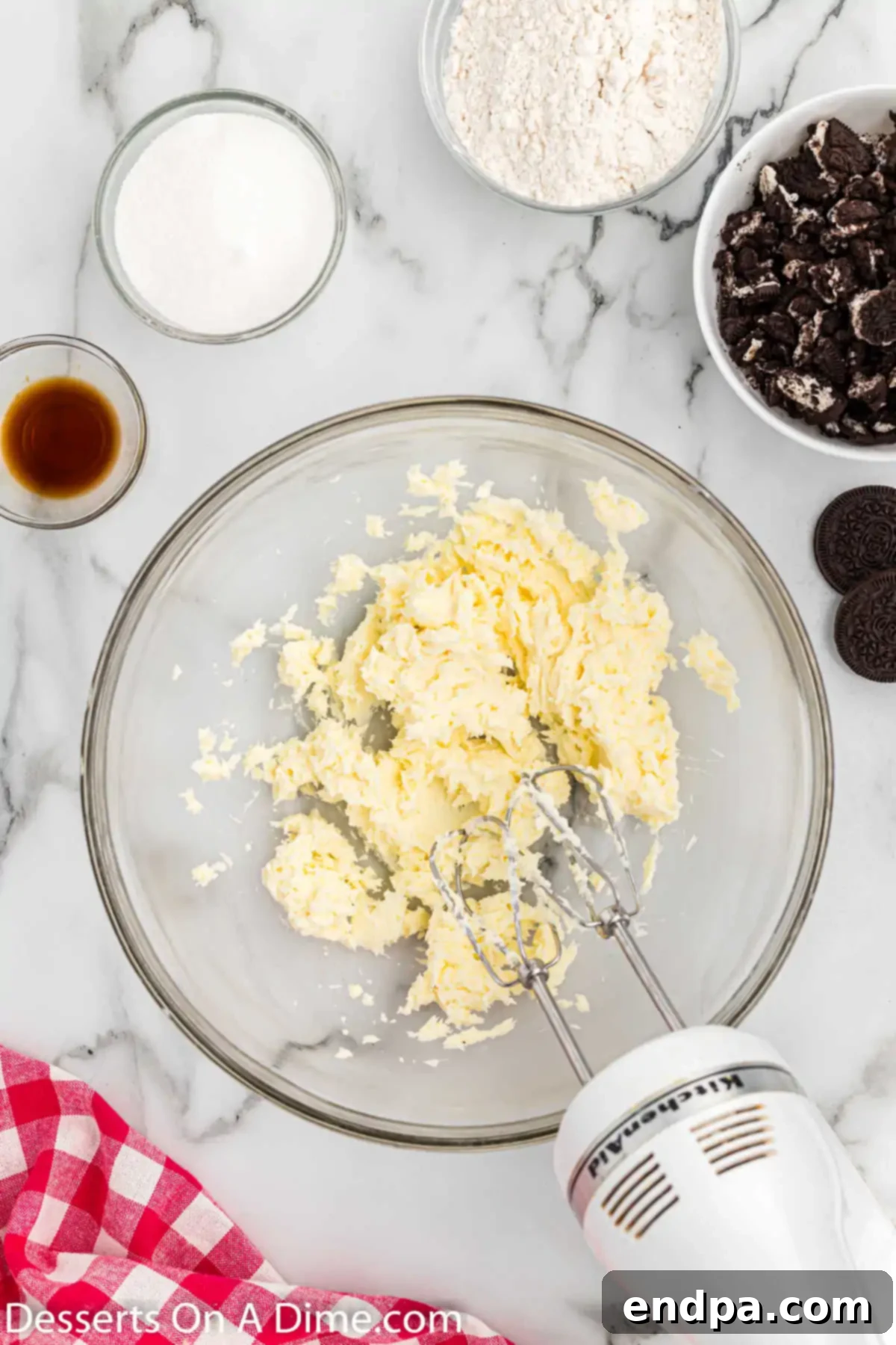 A mixing bowl with softened cream cheese and butter, ready to be beaten.