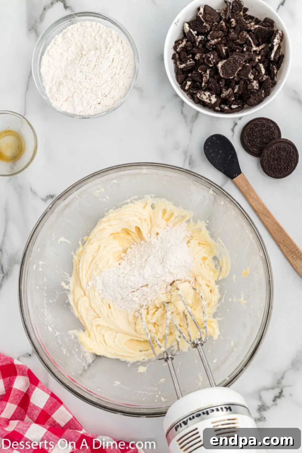 All-purpose flour being gradually mixed into the creamy cookie dough mixture.